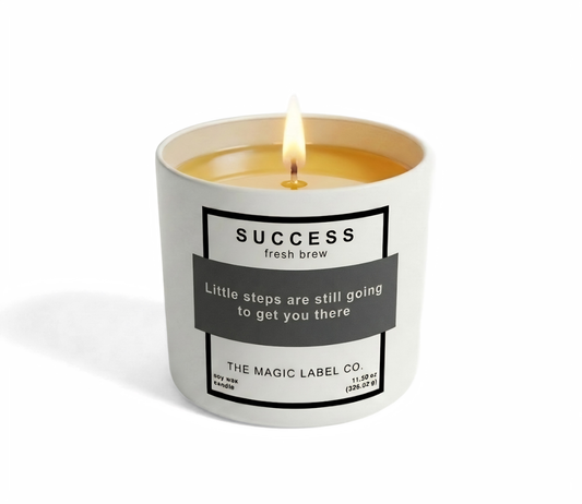 Success Candle from the magic label co. in a white container with the magic label activated showing hidden message