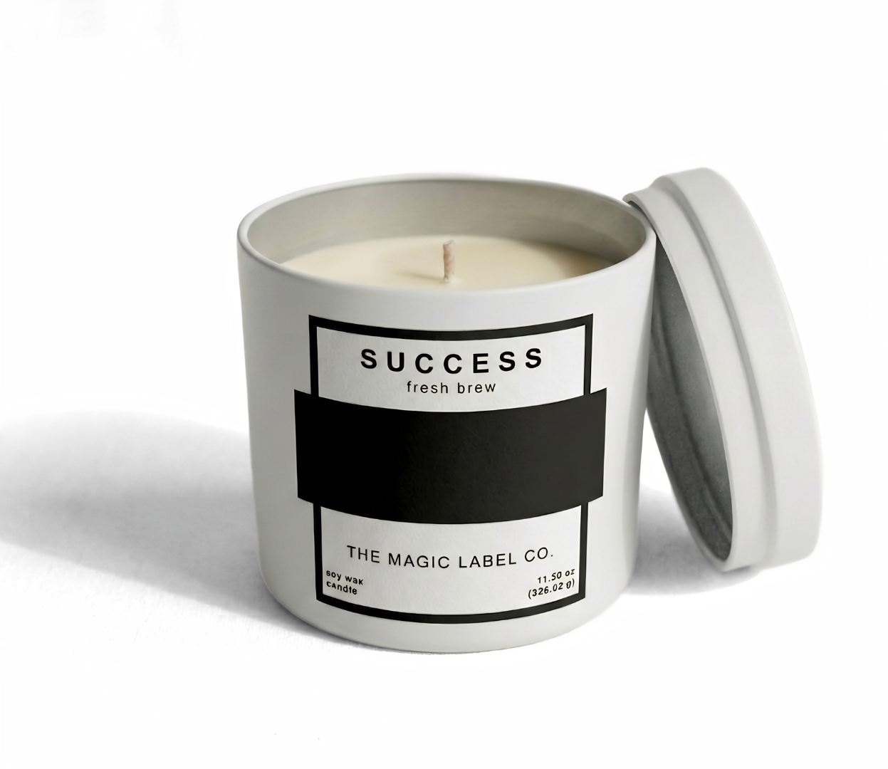 Success Candle from the magic label co. in a white container with open lid and the label is inactive hiding the message 